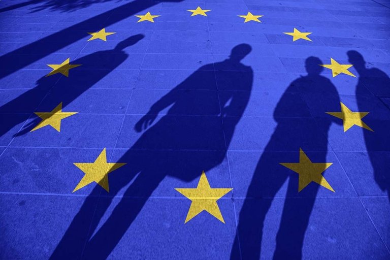 European Union flag painted on tiled street floor and shadows gr European Union flag painted on tiled street floor and shadows gr