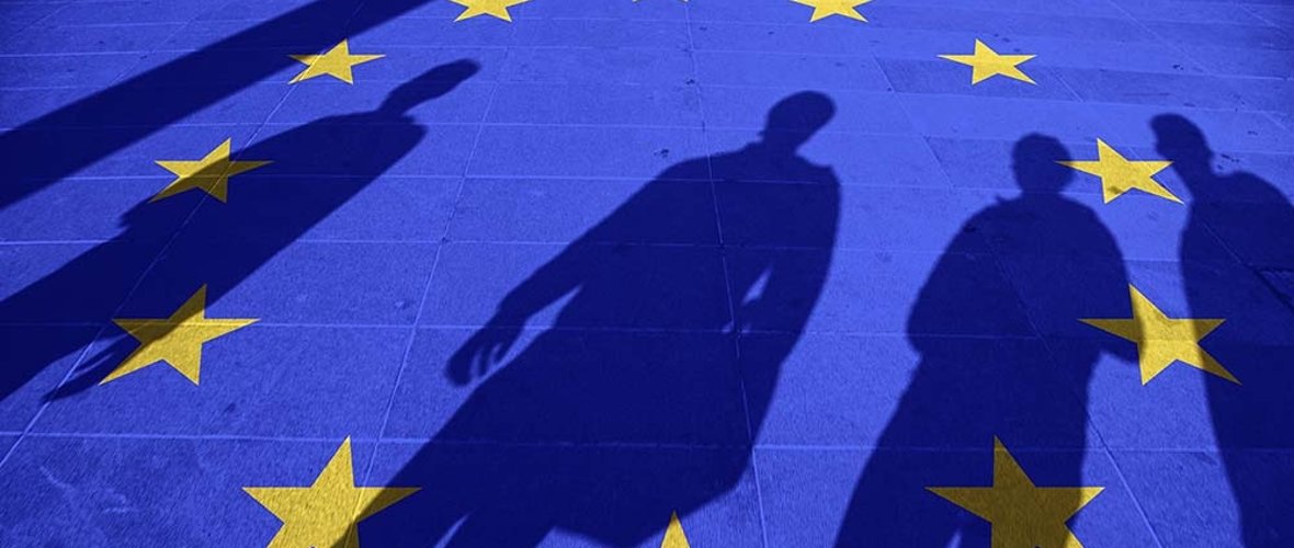 European Union flag painted on tiled street floor and shadows gr