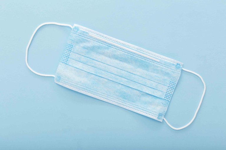 Medical mask, Medical protective mask on blue background. Disposable surgical face mask cover the mouth and nose. Healthcare and medical concept. Medical mask, Medical protective mask on blue background. Disposable surgical face mask cover the mouth and nose. Healthcare and medical concept.